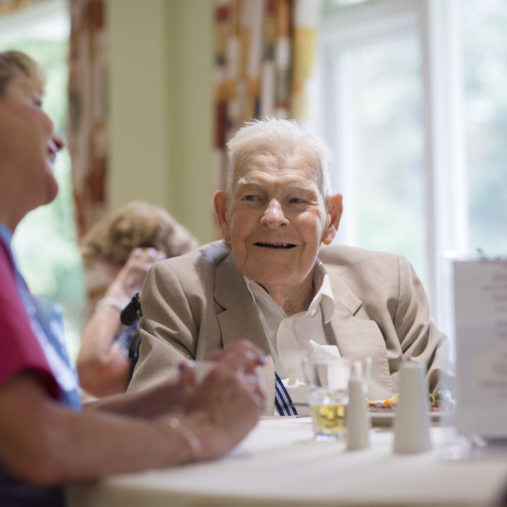Residents enjoying dinner with the care team at Norden House