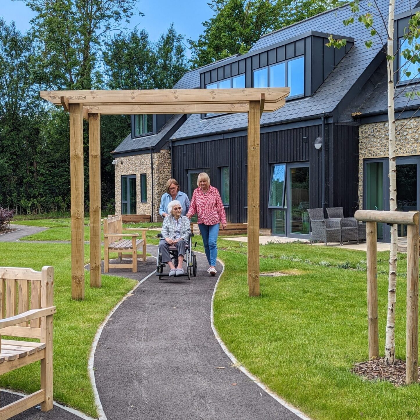 Residents taking a stroll through the gardens at Norden House
